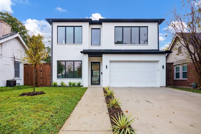 contemporary house featuring a garage, a front yard, and central air condition unit