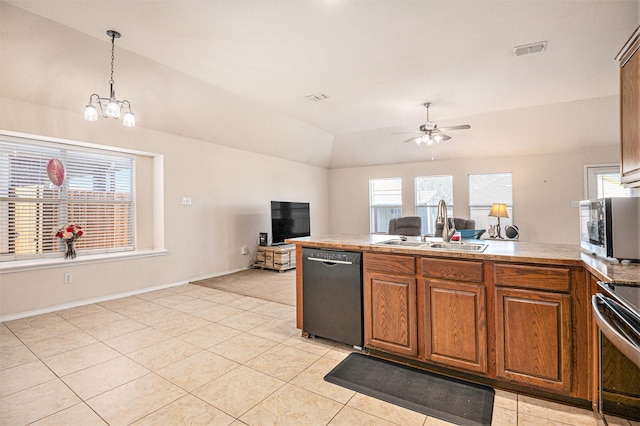 kitchen featuring sink, stainless steel appliances, decorative light fixtures, vaulted ceiling, and ceiling fan with notable chandelier