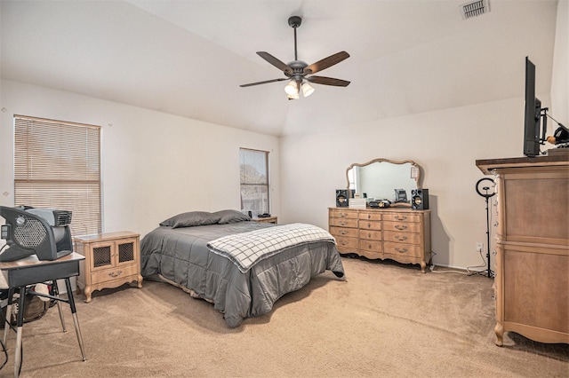 bedroom featuring ceiling fan, light carpet, and vaulted ceiling