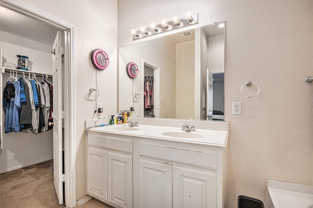 bathroom with vanity and a textured ceiling