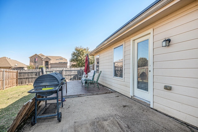 view of patio featuring a wooden deck and grilling area