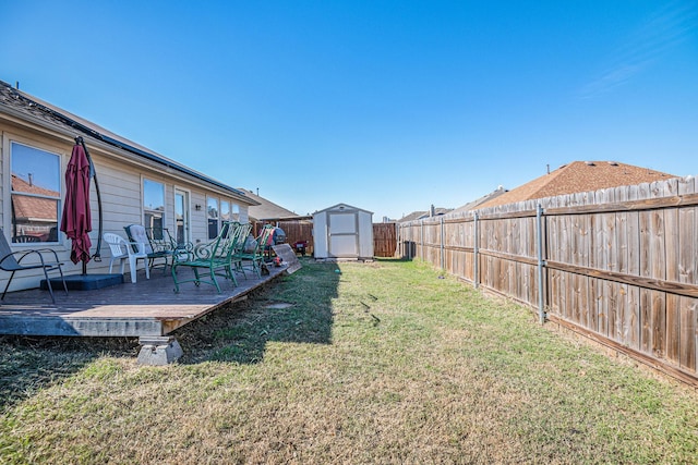 view of yard with a storage shed and a deck