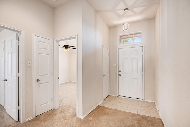 carpeted entrance foyer with ceiling fan