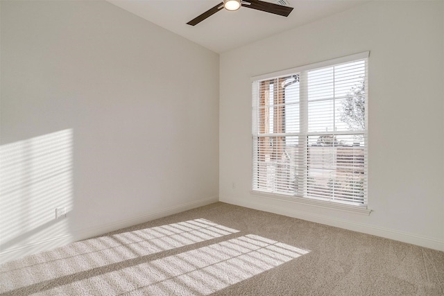 unfurnished room featuring carpet flooring, ceiling fan, and a wealth of natural light