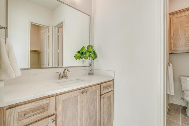 bathroom with tile patterned floors, vanity, and toilet