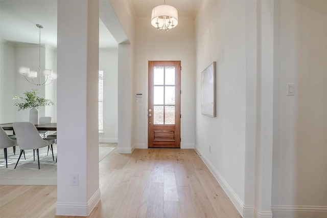 entrance foyer featuring light hardwood / wood-style flooring and an inviting chandelier