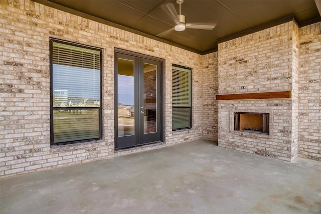 view of patio with ceiling fan and an outdoor brick fireplace