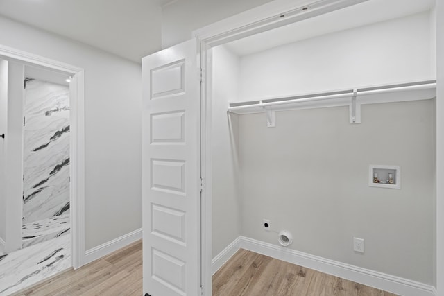 laundry room with hookup for an electric dryer, washer hookup, and light hardwood / wood-style flooring