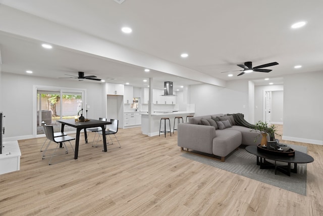 living room featuring ceiling fan and light wood-type flooring