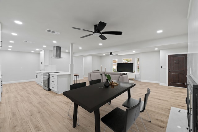 dining space featuring ceiling fan and light hardwood / wood-style floors