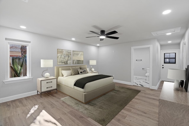 bedroom with ceiling fan, light hardwood / wood-style floors, and ensuite bathroom