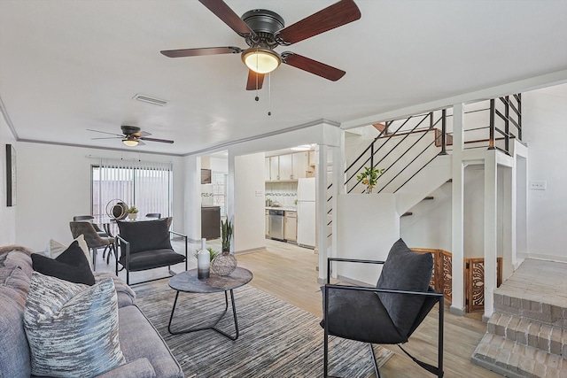 living room featuring ceiling fan and light hardwood / wood-style flooring