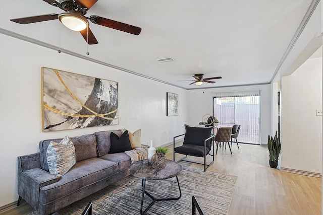 living room featuring wood-type flooring and ornamental molding