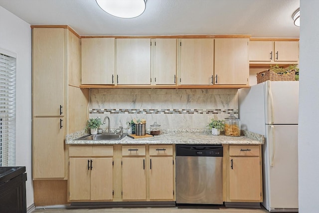 kitchen featuring tasteful backsplash, stainless steel dishwasher, sink, light brown cabinets, and white fridge