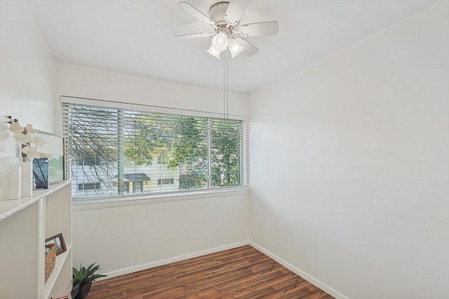 empty room with ceiling fan and dark hardwood / wood-style floors