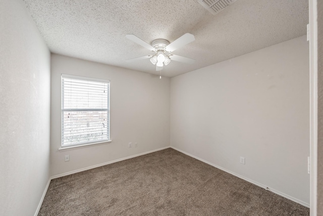 carpeted spare room featuring a textured ceiling and ceiling fan