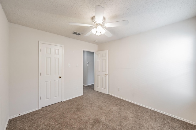 unfurnished bedroom with carpet flooring, a textured ceiling, and ceiling fan