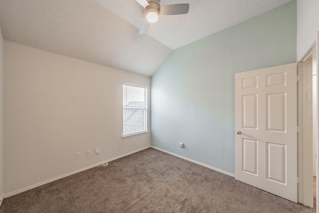 carpeted empty room featuring ceiling fan, a textured ceiling, and vaulted ceiling