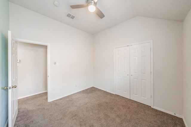 unfurnished bedroom featuring carpet, ceiling fan, lofted ceiling, and a closet