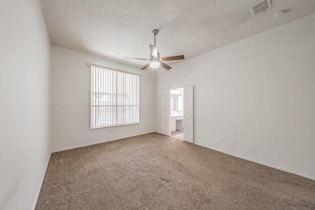 spare room with carpet flooring, a textured ceiling, and ceiling fan