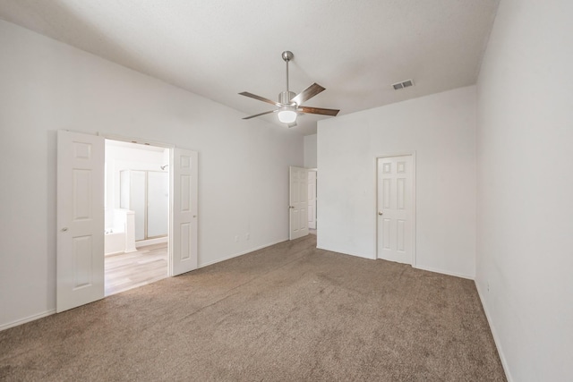 unfurnished bedroom with connected bathroom, ceiling fan, and carpet