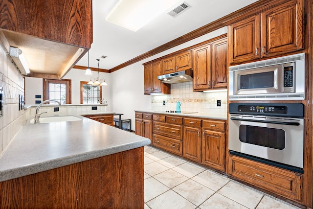 kitchen featuring light tile patterned flooring, sink, backsplash, stainless steel appliances, and crown molding