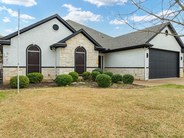 view of front of home with a front yard and a garage