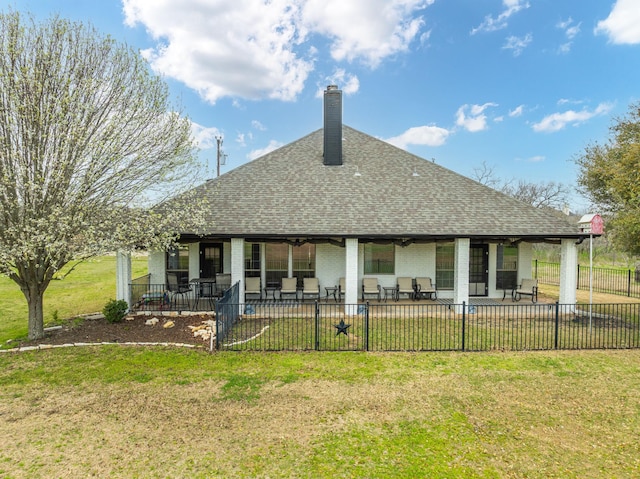 rear view of house featuring ceiling fan, a yard, and a patio area