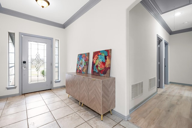 entrance foyer with crown molding and light tile patterned flooring