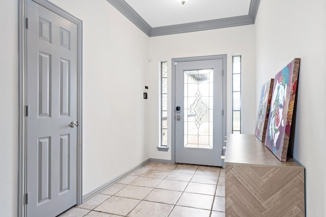 tiled foyer featuring ornamental molding