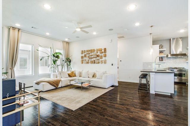 living room featuring dark hardwood / wood-style floors and ceiling fan