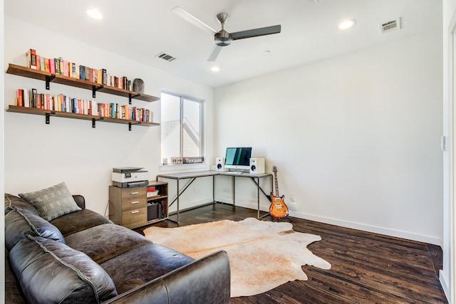 home office with dark hardwood / wood-style flooring and ceiling fan