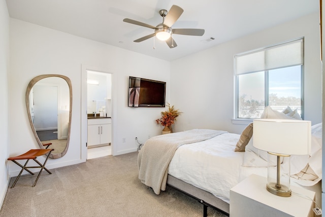 carpeted bedroom with ceiling fan and ensuite bathroom