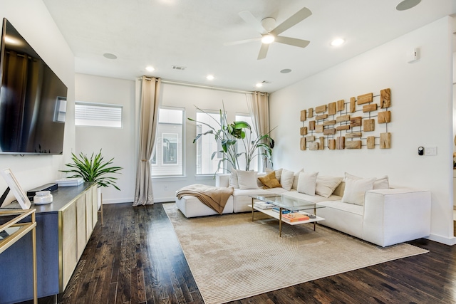 living room featuring ceiling fan and dark hardwood / wood-style floors