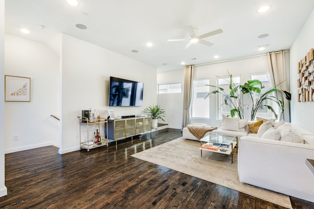 living room featuring ceiling fan and dark wood-type flooring