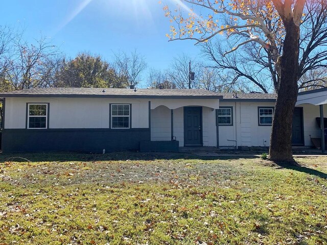 ranch-style home with a front lawn