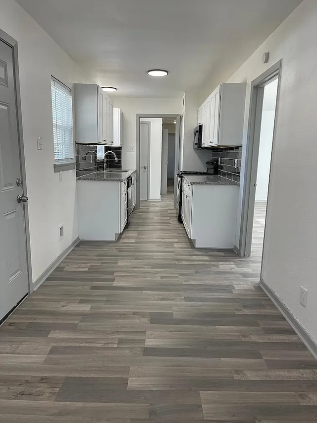 kitchen featuring tasteful backsplash, sink, white cabinets, and stainless steel appliances