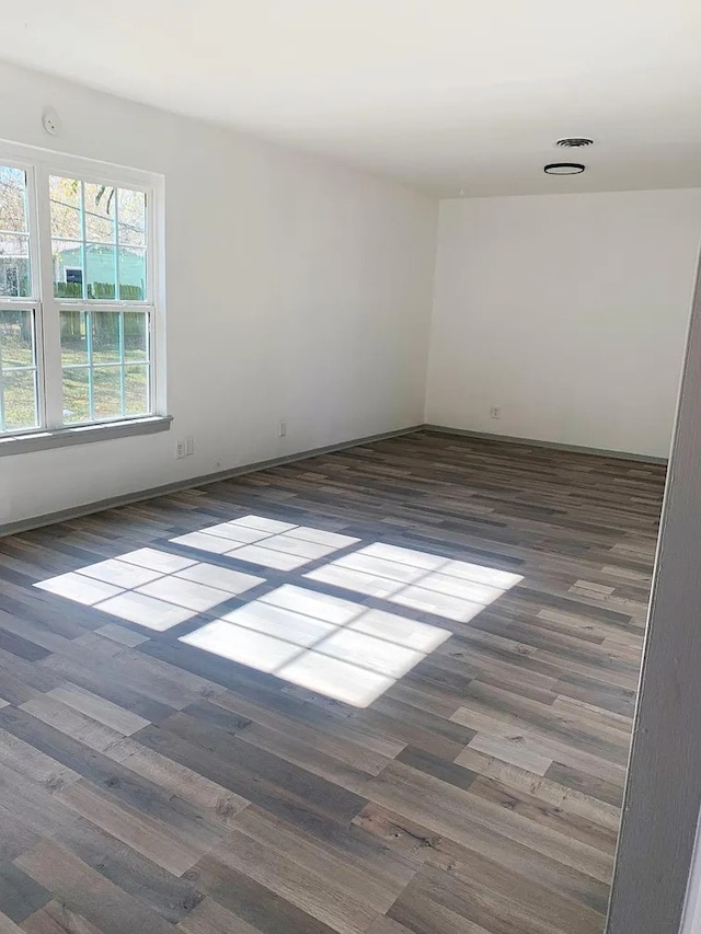 empty room with dark hardwood / wood-style floors