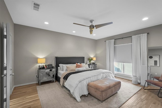 bedroom with ceiling fan and light hardwood / wood-style flooring