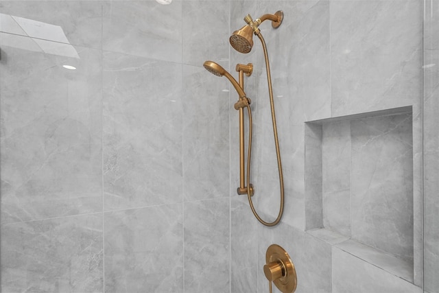 interior details featuring tiled shower