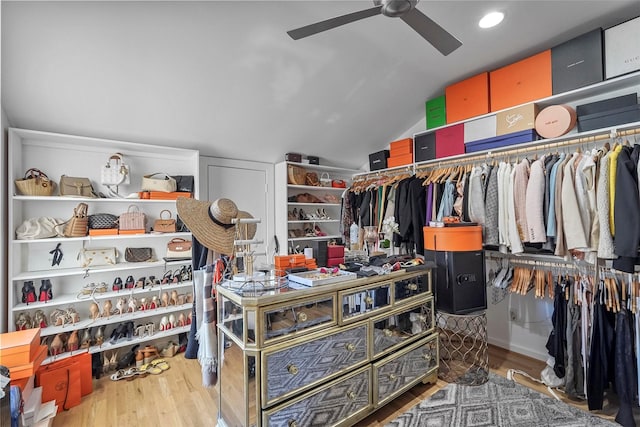 spacious closet featuring ceiling fan, hardwood / wood-style floors, and vaulted ceiling