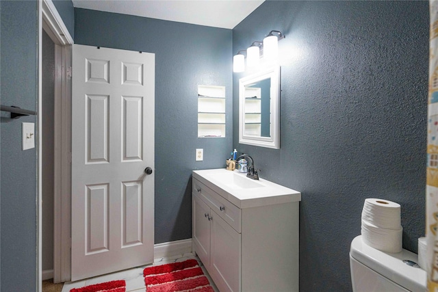 bathroom featuring vanity and toilet