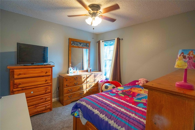 bedroom featuring ceiling fan, carpet floors, and a textured ceiling