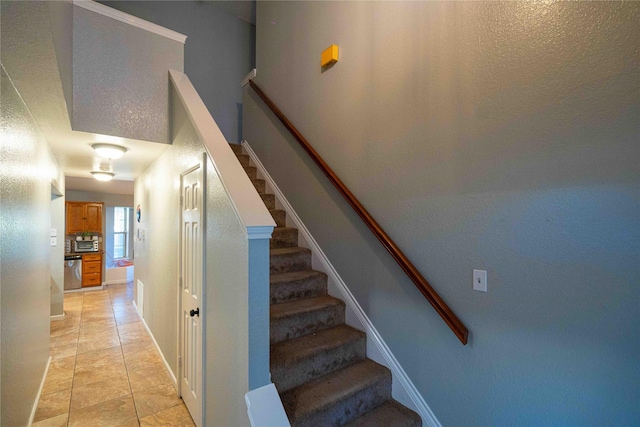 staircase featuring tile patterned floors