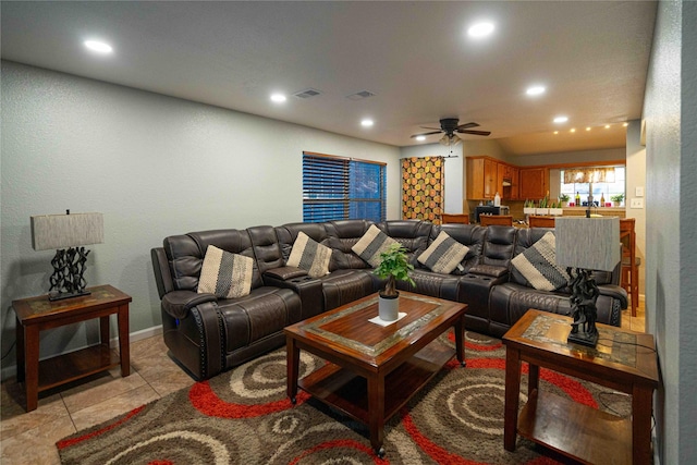 living room with ceiling fan and light tile patterned floors