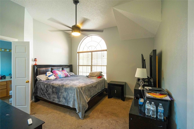 bedroom featuring ceiling fan, lofted ceiling, carpet floors, and a textured ceiling