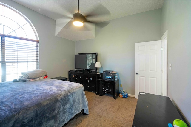 carpeted bedroom featuring lofted ceiling and ceiling fan