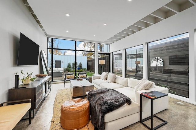 living room featuring a wall of windows