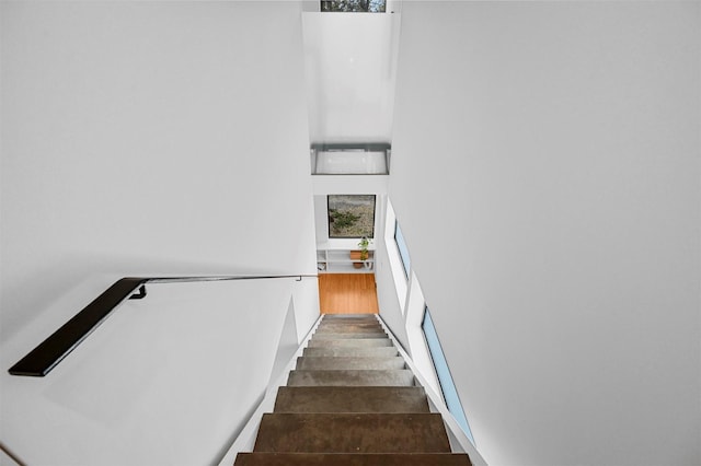 staircase with hardwood / wood-style flooring