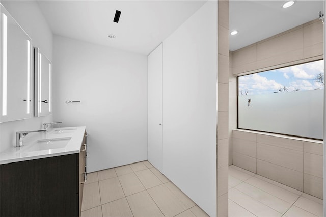 bathroom featuring vanity, tile patterned floors, and tile walls